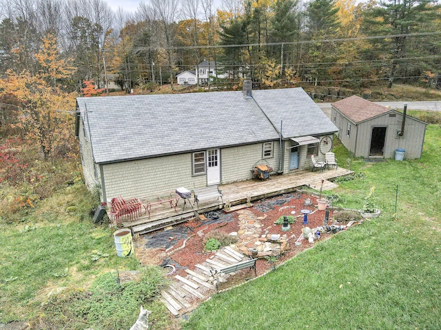 405 Pond Rd, Sidney, ME 04330 - back of property featuring a yard, a deck, an outbuilding, and a forest view