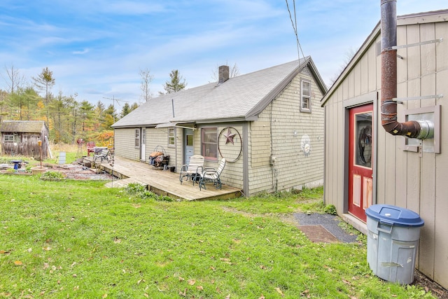 405 Pond Rd, Sidney, ME 04330 - rear view of house featuring a lawn, an outdoor structure, and a wooden deck