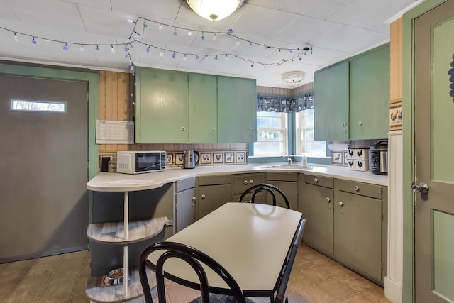 405 Pond Rd, Sidney, ME 04330 - kitchen featuring green cabinetry, a sink, light countertops, decorative backsplash, and light tile patterned floors