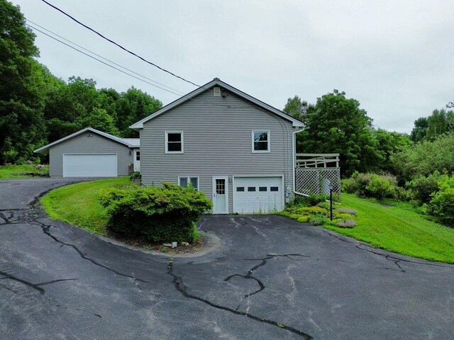 222 Ward Rd, Augusta, ME 04330 - view of side of home featuring a garage, a lawn, and a forest view