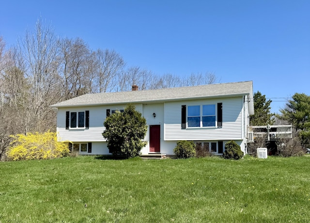 12 Grace Snow Dr, Glenburn, ME 04401 - split foyer home featuring a front yard, a chimney, and entry steps