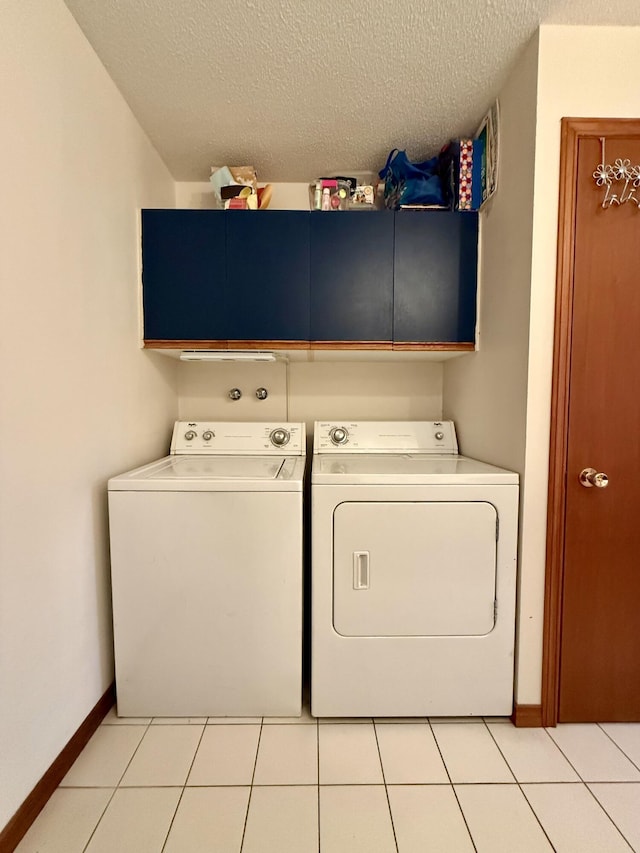 12 Grace Snow Dr, Glenburn, ME 04401 - washroom featuring cabinet space, washing machine and dryer, a textured ceiling, baseboards, and light tile patterned floors