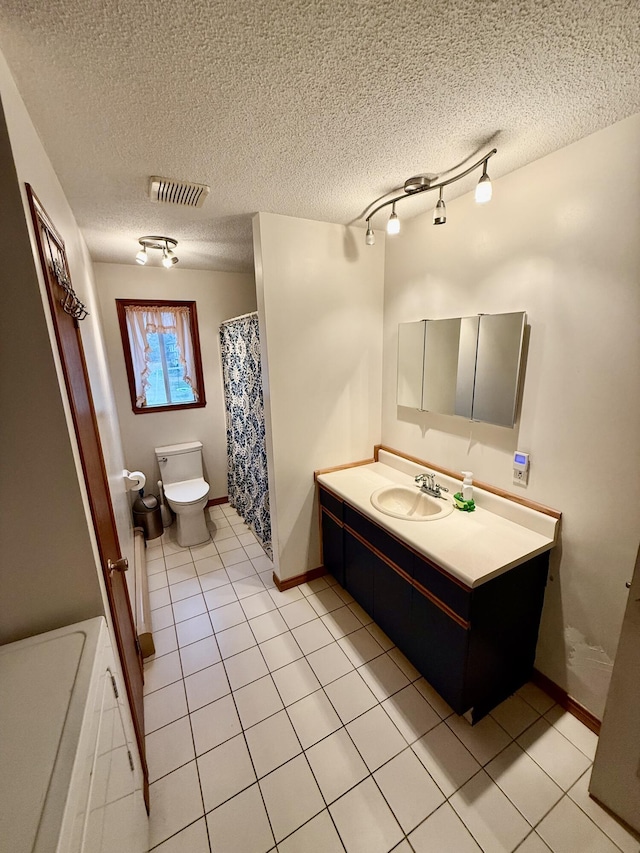12 Grace Snow Dr, Glenburn, ME 04401 - full bathroom with toilet, vanity, tile patterned floors, baseboards, and a textured ceiling