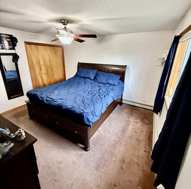 12 Grace Snow Dr, Glenburn, ME 04401 - carpeted bedroom with a baseboard heating unit, ceiling fan, and a textured ceiling