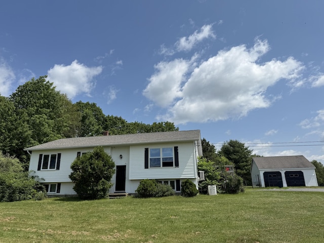 12 Grace Snow Dr, Glenburn, ME 04401 - raised ranch featuring a garage, a front lawn, entry steps, and an outbuilding