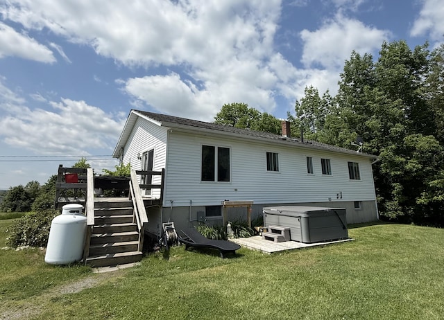 12 Grace Snow Dr, Glenburn, ME 04401 - back of property with a hot tub, a lawn, a wooden deck, stairway, and a chimney