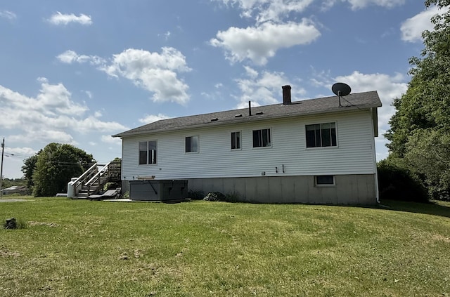 12 Grace Snow Dr, Glenburn, ME 04401 - back of house with a hot tub, a yard, a chimney, and stairs