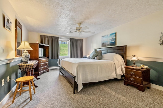 1373 Post Rd Unit 4A, Wells, ME 04090 - carpeted bedroom featuring a textured ceiling, baseboards, ceiling fan, and baseboard heating