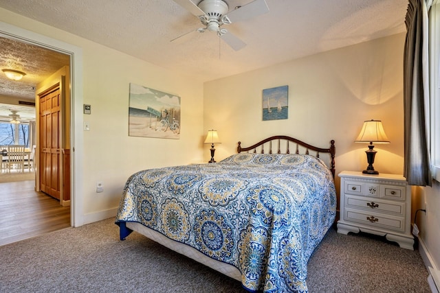 1373 Post Rd Unit 4A, Wells, ME 04090 - carpeted bedroom featuring a textured ceiling, baseboards, and ceiling fan