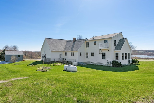 61 Pond Rd, Albion, ME 04910 - back of property with a lawn, a chimney, a balcony, and roof with shingles
