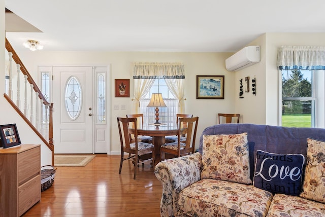61 Pond Rd, Albion, ME 04910 - interior space featuring baseboards, a wall mounted AC, wood finished floors, and stairway