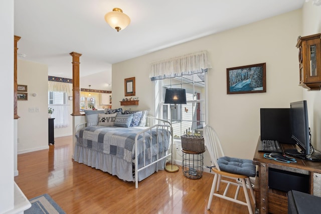 61 Pond Rd, Albion, ME 04910 - bedroom with baseboards, ornate columns, and wood finished floors