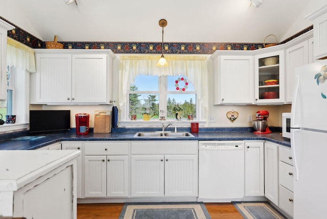 61 Pond Rd, Albion, ME 04910 - kitchen featuring vaulted ceiling, light wood-type flooring, a sink, white cabinets, and white appliances