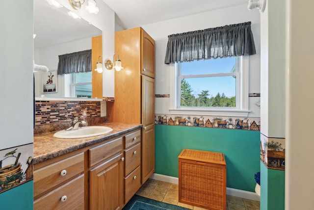 61 Pond Rd, Albion, ME 04910 - bathroom featuring vanity, tasteful backsplash, baseboards, and tile patterned floors