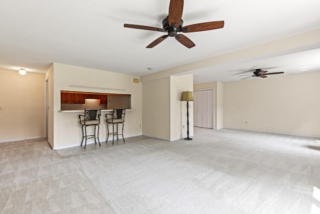 161 Saco Ave Unit 404, Old Orchard Beach, ME 04064 - living area featuring light colored carpet, ceiling fan, and baseboards