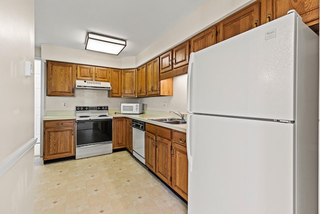 161 Saco Ave Unit 404, Old Orchard Beach, ME 04064 - kitchen featuring white appliances, exhaust hood, brown cabinetry, light countertops, and a sink