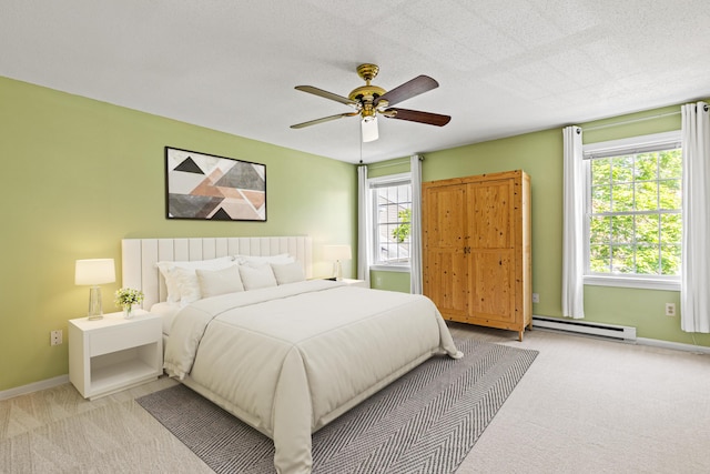161 Saco Ave Unit 404, Old Orchard Beach, ME 04064 - bedroom with a baseboard heating unit, carpet, baseboards, and ceiling fan