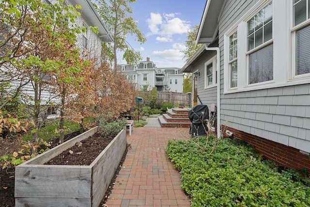 14 Codman St, Portland, ME 04103 - view of community with a vegetable garden, fence, and a patio area