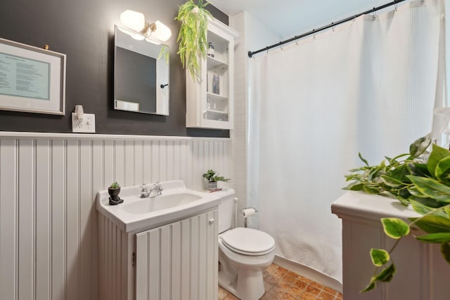 14 Codman St, Portland, ME 04103 - full bath with toilet, wainscoting, vanity, and a shower with curtain