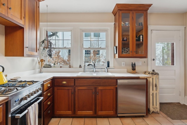 14 Codman St, Portland, ME 04103 - kitchen with a sink, dishwasher, stainless steel gas range, light countertops, and brown cabinets