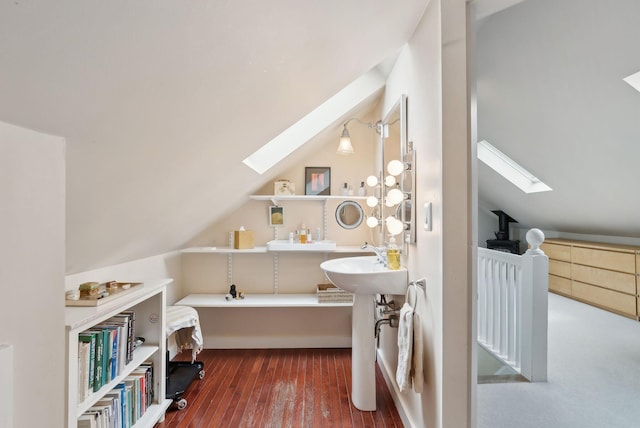 14 Codman St, Portland, ME 04103 - bathroom featuring a skylight, wood finished floors, vaulted ceiling, and a sink