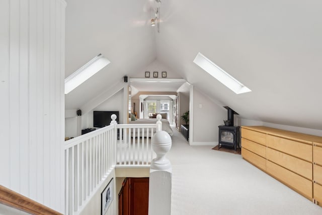 14 Codman St, Portland, ME 04103 - additional living space featuring a wood stove, a skylight, vaulted ceiling, and carpet floors