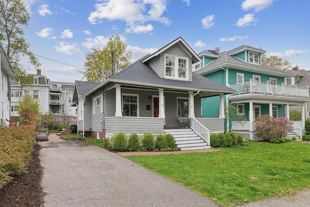 14 Codman St, Portland, ME 04103 - view of front facade featuring covered porch, a shingled roof, a front lawn, and asphalt driveway