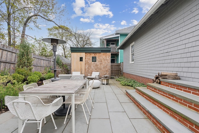 14 Codman St, Portland, ME 04103 - view of patio / terrace featuring fence, outdoor dining area, and an outbuilding