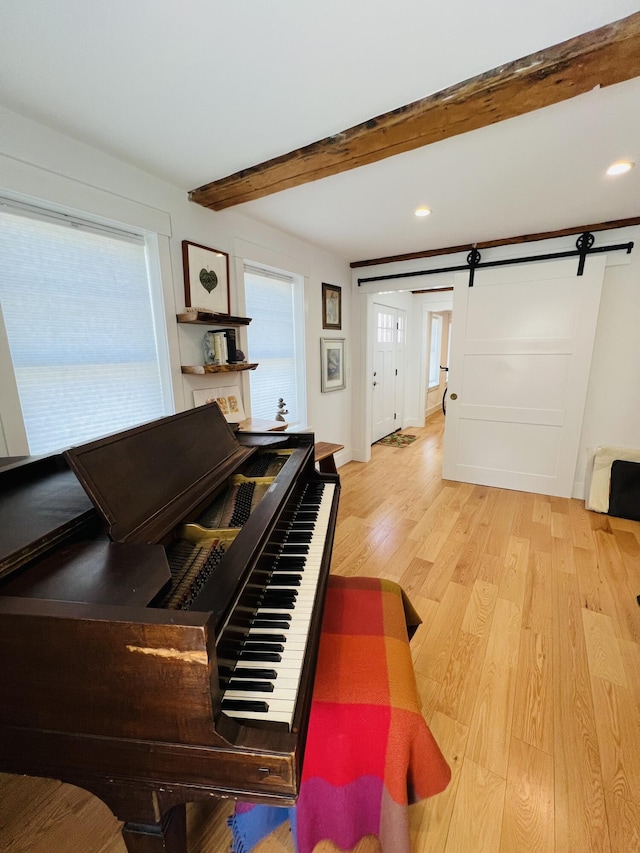 157 Ellsworth Rd, Blue Hill, ME 04614 - corridor with a barn door, beam ceiling, wood finished floors, plenty of natural light, and recessed lighting