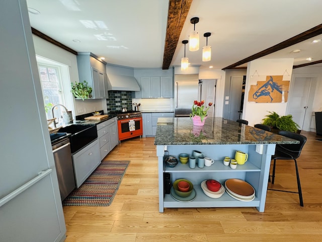 157 Ellsworth Rd, Blue Hill, ME 04614 - kitchen featuring open shelves, high quality appliances, custom exhaust hood, a breakfast bar area, and light wood-style floors