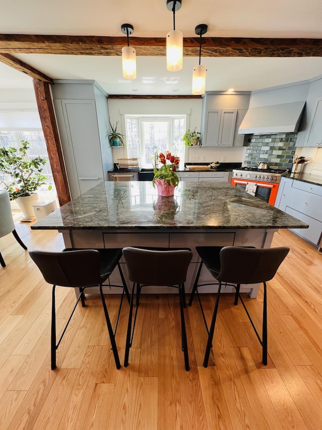157 Ellsworth Rd, Blue Hill, ME 04614 - kitchen featuring high end stove, beam ceiling, custom exhaust hood, gray cabinetry, and healthy amount of natural light