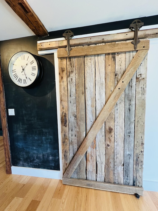 157 Ellsworth Rd, Blue Hill, ME 04614 - detailed view of beam ceiling, wood finished floors, and a barn door