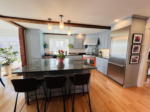 157 Ellsworth Rd, Blue Hill, ME 04614 - kitchen with high quality appliances, beamed ceiling, a kitchen bar, light wood finished floors, and recessed lighting