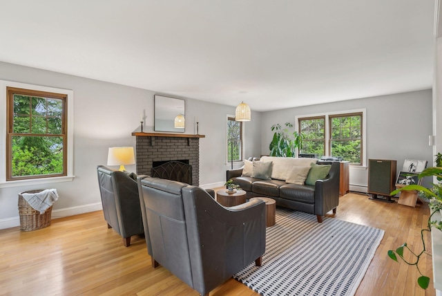 26 Hunts Point Rd, Cape Elizabeth, ME 04107 - living area with a baseboard heating unit, light wood-style floors, baseboards, and a fireplace