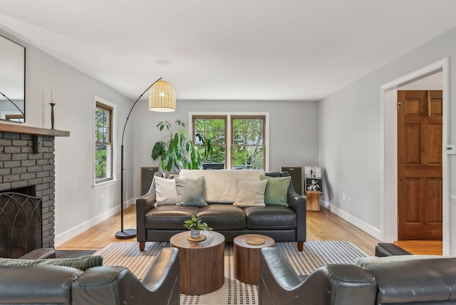 26 Hunts Point Rd, Cape Elizabeth, ME 04107 - living room with light wood finished floors, baseboards, and a fireplace
