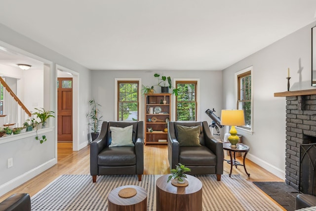 26 Hunts Point Rd, Cape Elizabeth, ME 04107 - living area featuring a fireplace, baseboards, and light wood finished floors