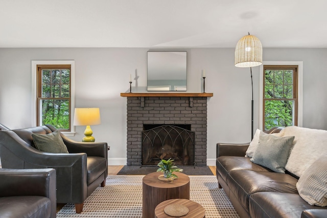 26 Hunts Point Rd, Cape Elizabeth, ME 04107 - living room featuring wood finished floors, a brick fireplace, and baseboards