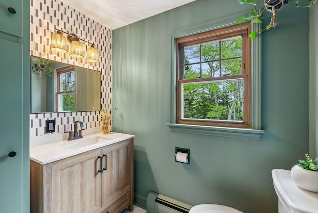 26 Hunts Point Rd, Cape Elizabeth, ME 04107 - half bath with a baseboard radiator, toilet, healthy amount of natural light, and tasteful backsplash