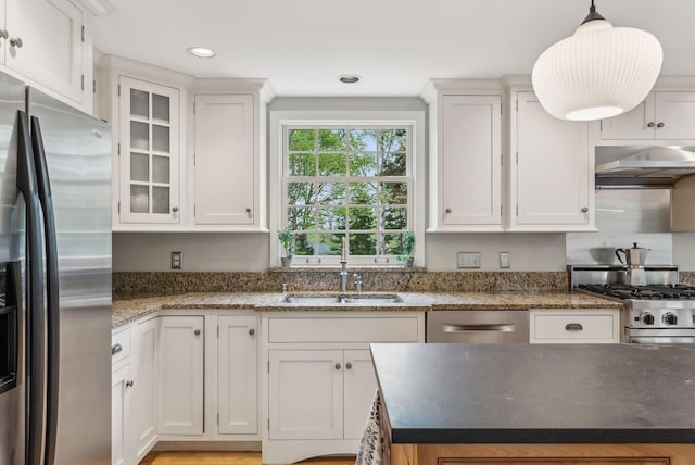 26 Hunts Point Rd, Cape Elizabeth, ME 04107 - kitchen with stainless steel appliances, ventilation hood, white cabinetry, a sink, and pendant lighting
