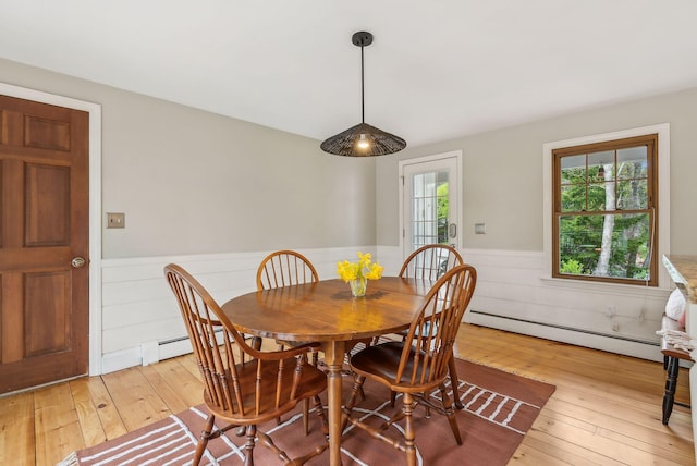 26 Hunts Point Rd, Cape Elizabeth, ME 04107 - dining room with baseboard heating, a wainscoted wall, and light wood-type flooring