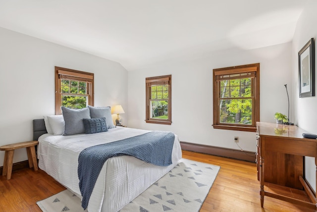26 Hunts Point Rd, Cape Elizabeth, ME 04107 - bedroom featuring a baseboard radiator, multiple windows, and light wood-type flooring