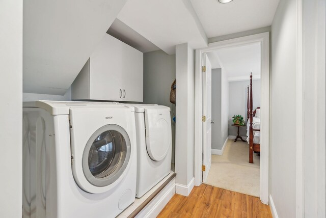 26 Hunts Point Rd, Cape Elizabeth, ME 04107 - washroom featuring washing machine and dryer, light wood-style floors, and baseboards