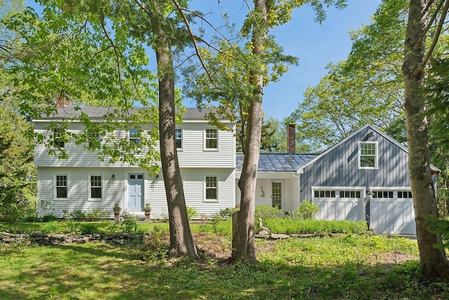 26 Hunts Point Rd, Cape Elizabeth, ME 04107 - back of property with a chimney, an attached garage, and board and batten siding