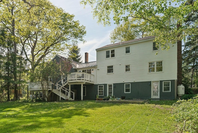 26 Hunts Point Rd, Cape Elizabeth, ME 04107 - rear view of house with a deck, a standing seam roof, stairway, a lawn, and a chimney