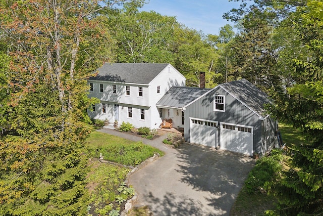 26 Hunts Point Rd, Cape Elizabeth, ME 04107 - colonial inspired home with asphalt driveway, a chimney, an attached garage, and roof with shingles