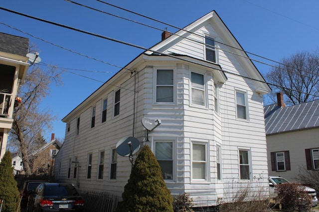 13 Halde St, Waterville, ME 04901 - view of property exterior with a chimney