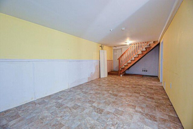 16 Dragonfly Ln, Kennebunkport, ME 04046 - finished basement with stairs, stone finish floors, and wainscoting