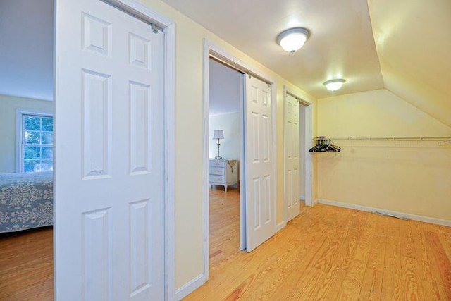 16 Dragonfly Ln, Kennebunkport, ME 04046 - hallway with light wood-type flooring, vaulted ceiling, and baseboards