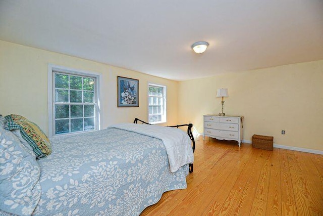 16 Dragonfly Ln, Kennebunkport, ME 04046 - bedroom featuring multiple windows, light wood-type flooring, and baseboards