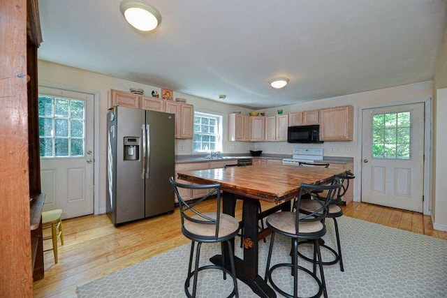 16 Dragonfly Ln, Kennebunkport, ME 04046 - kitchen featuring stainless steel refrigerator with ice dispenser, black microwave, white range with electric cooktop, light wood-style floors, and plenty of natural light